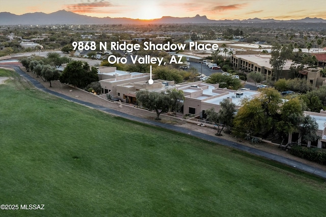 aerial view at dusk featuring a mountain view