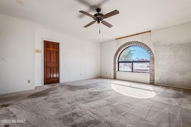 empty room featuring carpet flooring and ceiling fan