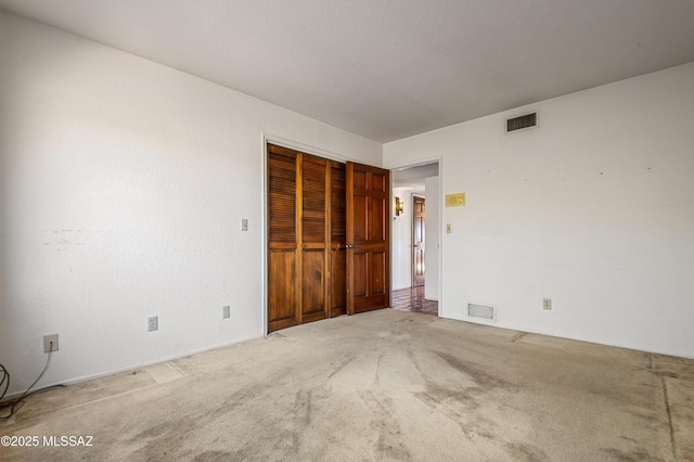 unfurnished bedroom with carpet flooring and a closet