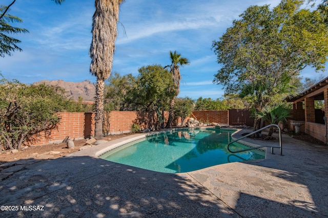 view of pool with a mountain view and a patio