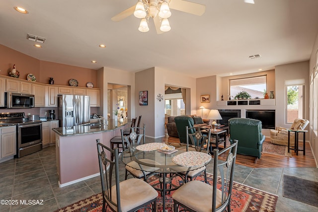 dining area with ceiling fan, a healthy amount of sunlight, and sink