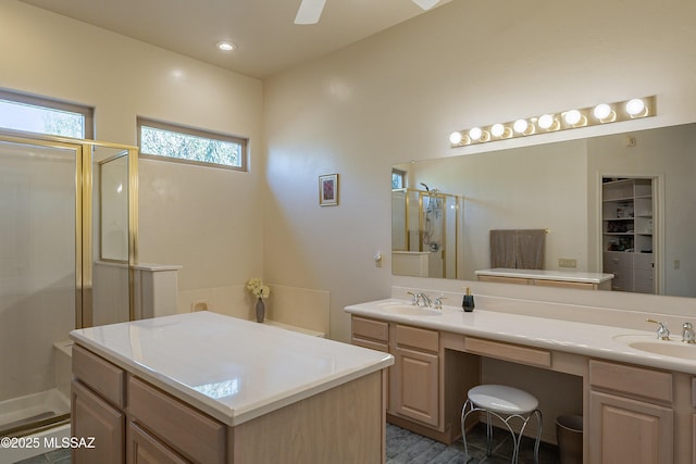 bathroom with ceiling fan, walk in shower, and vanity