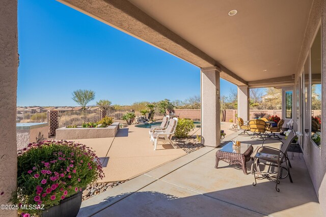 view of patio with a fenced in pool