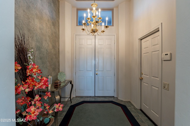 tiled entryway with a notable chandelier and a high ceiling