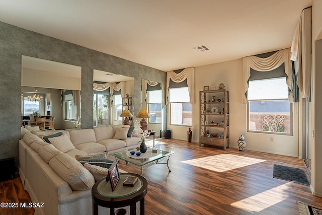 living room with an inviting chandelier and hardwood / wood-style flooring