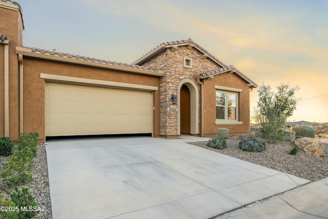 mediterranean / spanish-style home with a garage