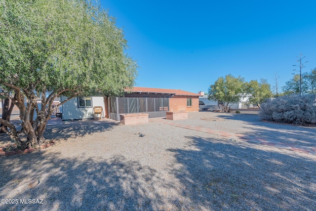 view of yard with a sunroom and a patio