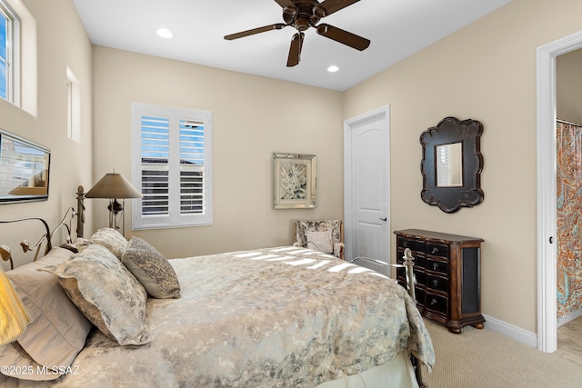 bedroom featuring ceiling fan and light carpet