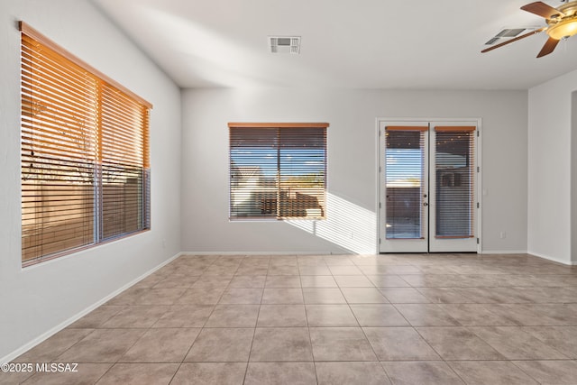 spare room with ceiling fan, french doors, and light tile patterned floors