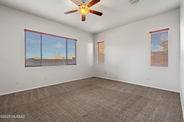 7826 W Sage Creek Ct, Tucson, AZ 85743 - unfurnished room with dark colored carpet, ceiling fan, and baseboards