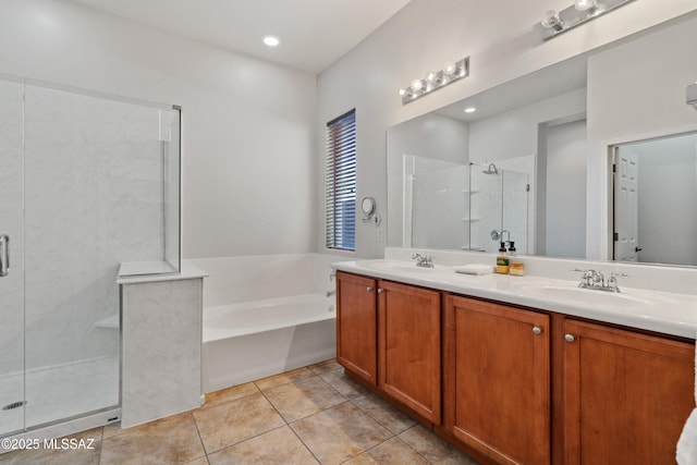 bathroom featuring tile patterned floors, vanity, and shower with separate bathtub