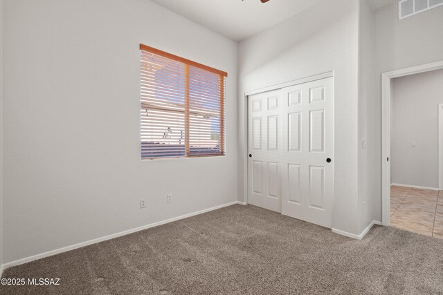 unfurnished bedroom featuring carpet flooring and a closet