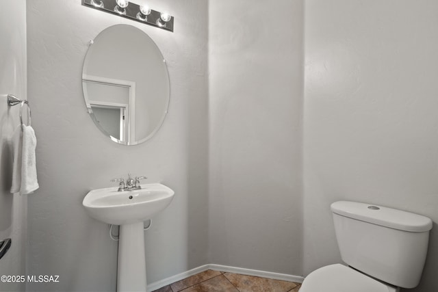 bathroom featuring tile patterned flooring and toilet