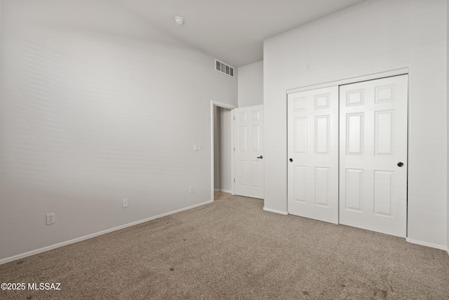 unfurnished bedroom with carpet flooring and a closet