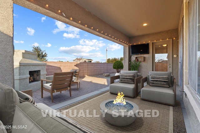 7826 W Sage Creek Ct, Tucson, AZ 85743 - view of patio / terrace with an outdoor living space with a fireplace and fence