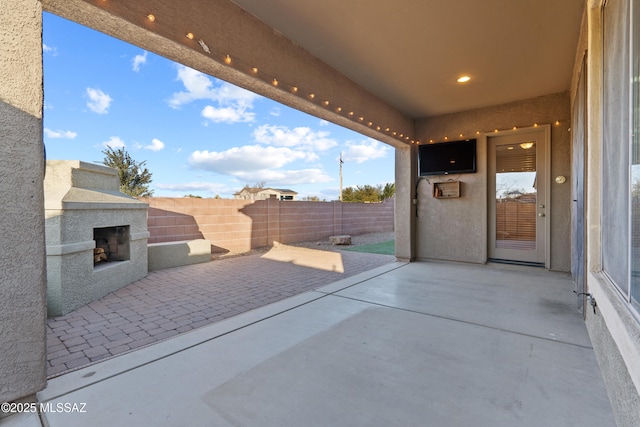 7826 W Sage Creek Ct, Tucson, AZ 85743 - view of patio featuring exterior fireplace and fence