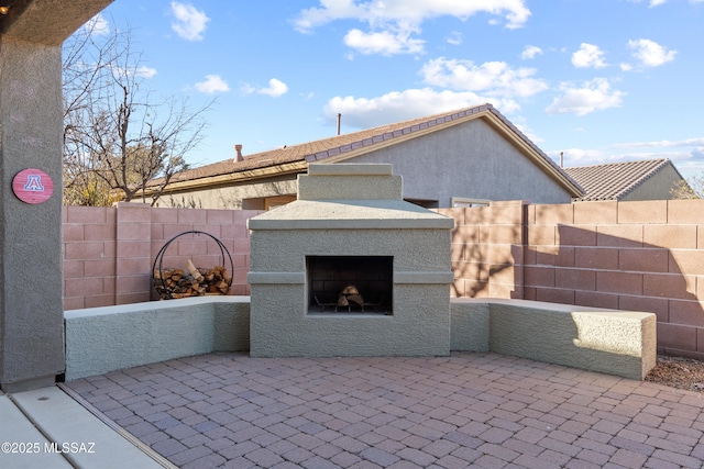 view of patio / terrace featuring an outdoor fireplace