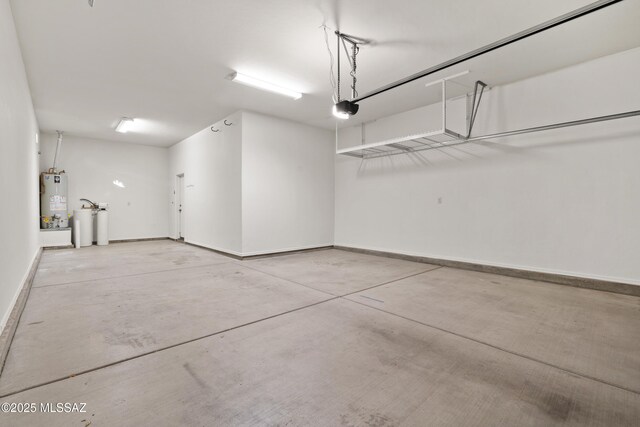 7826 W Sage Creek Ct, Tucson, AZ 85743 - garage with gas water heater, a garage door opener, and baseboards