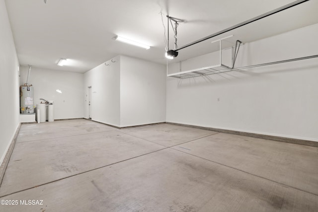 garage featuring a garage door opener and water heater