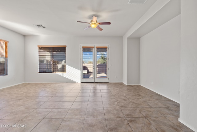 tiled empty room with ceiling fan