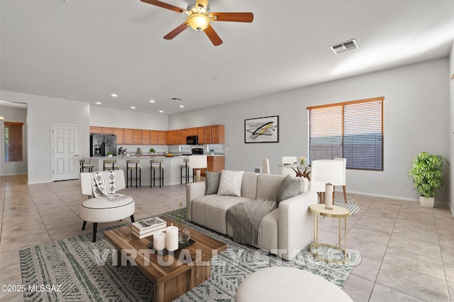 tiled living room with ceiling fan