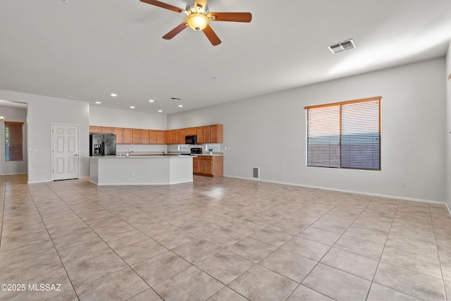 unfurnished living room featuring ceiling fan and light tile patterned flooring