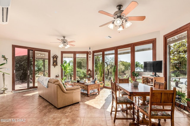 sunroom / solarium featuring visible vents, plenty of natural light, and tile patterned flooring
