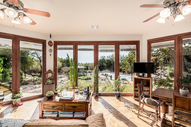 sunroom / solarium with tile patterned floors, visible vents, and french doors