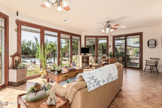 tiled living room with ceiling fan