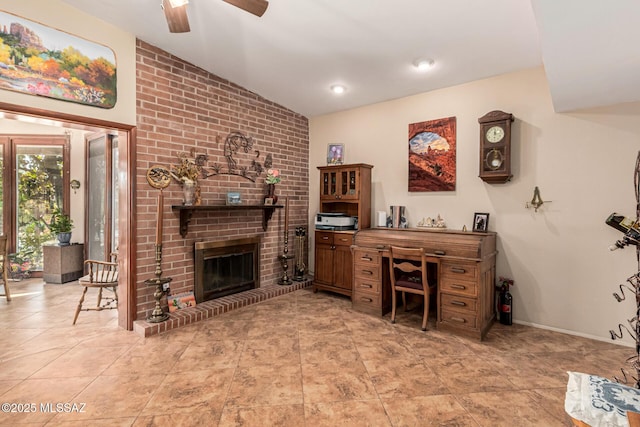 office area featuring ceiling fan, light tile patterned floors, and a brick fireplace