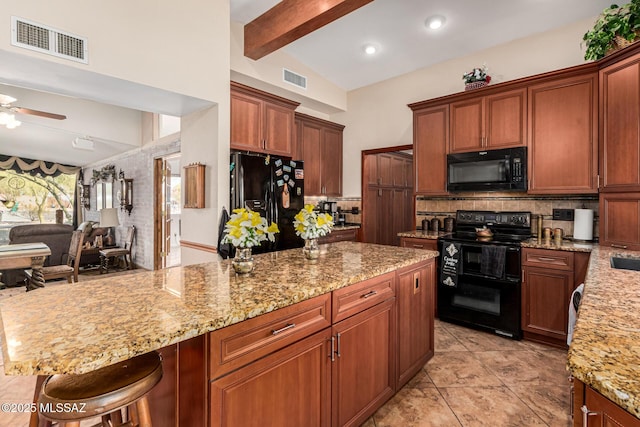 kitchen with lofted ceiling with beams, ceiling fan, black appliances, a breakfast bar area, and tasteful backsplash