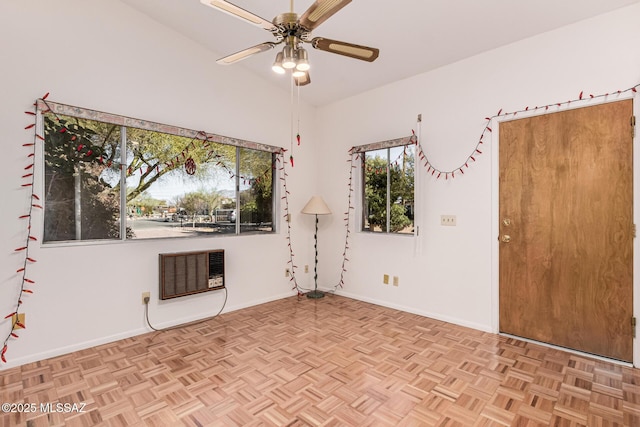 unfurnished room with ceiling fan, heating unit, and baseboards