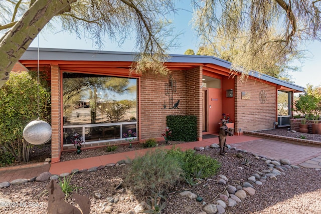 view of front of house featuring brick siding