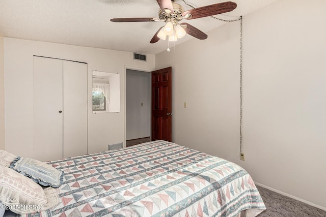 bedroom featuring ceiling fan, carpet flooring, a textured ceiling, and a closet