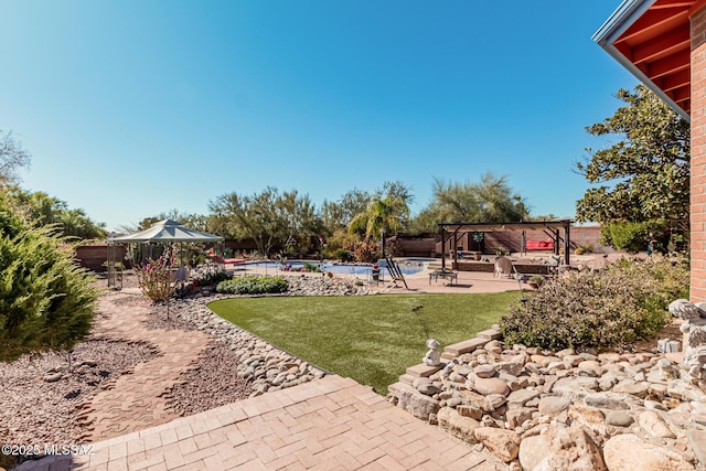 view of yard featuring a pergola, a patio, and a pool