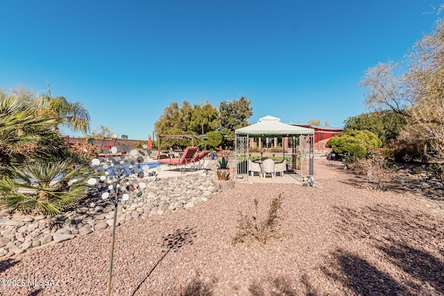 view of yard featuring a gazebo and a patio