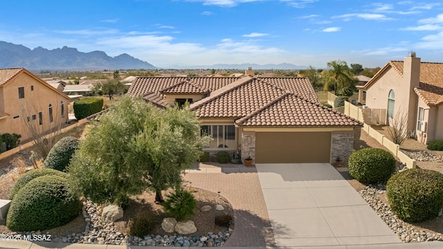 view of front of home featuring a mountain view and a garage