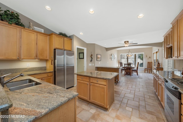 kitchen with vaulted ceiling, a kitchen island, sink, kitchen peninsula, and stainless steel appliances