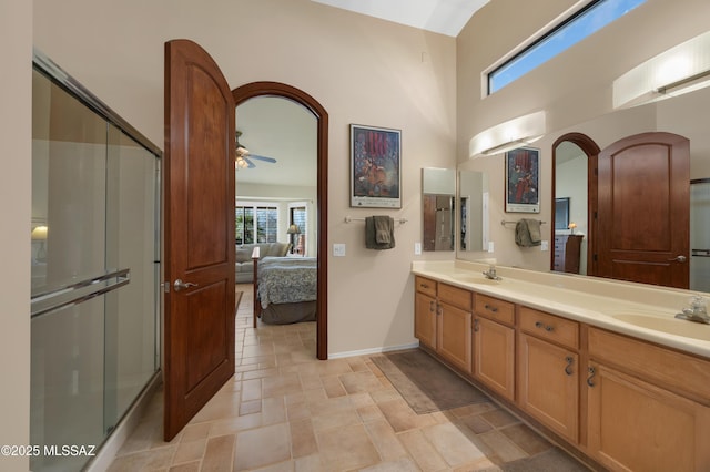 bathroom featuring ceiling fan, vanity, and a shower with shower door