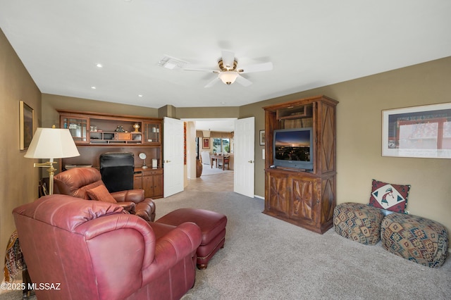 living room with light colored carpet and ceiling fan