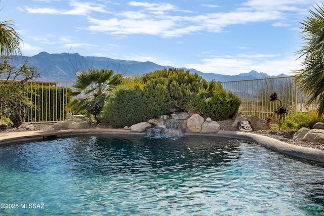 view of pool featuring a mountain view and pool water feature