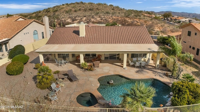 view of pool with a patio and a mountain view