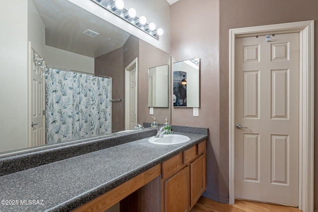 bathroom with hardwood / wood-style floors and vanity