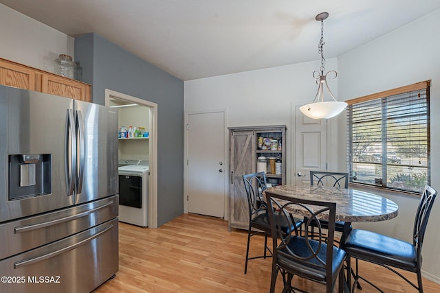 dining space with light hardwood / wood-style floors and washer / dryer