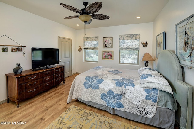 bedroom featuring ceiling fan, a closet, and light hardwood / wood-style floors