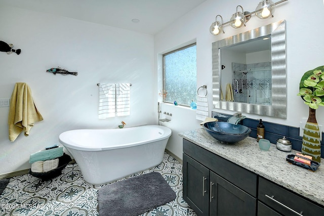 bathroom with tile patterned floors, vanity, and plus walk in shower