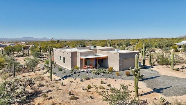 view of front of house with a garage and a mountain view