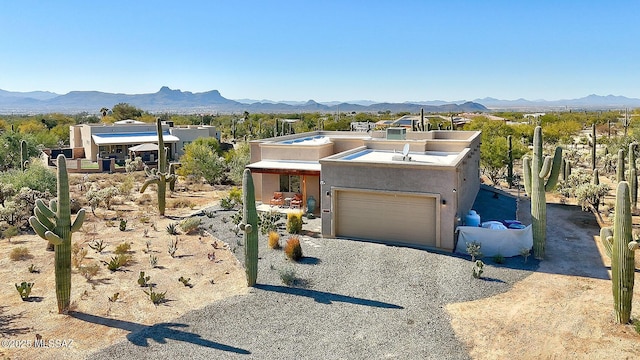 view of front of property with a mountain view and a garage