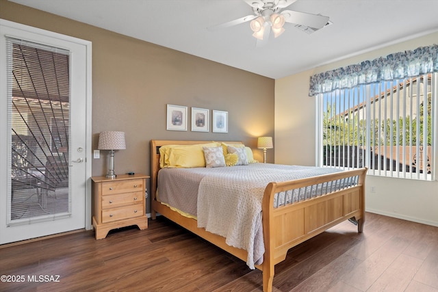 bedroom with access to exterior, ceiling fan, and dark wood-type flooring