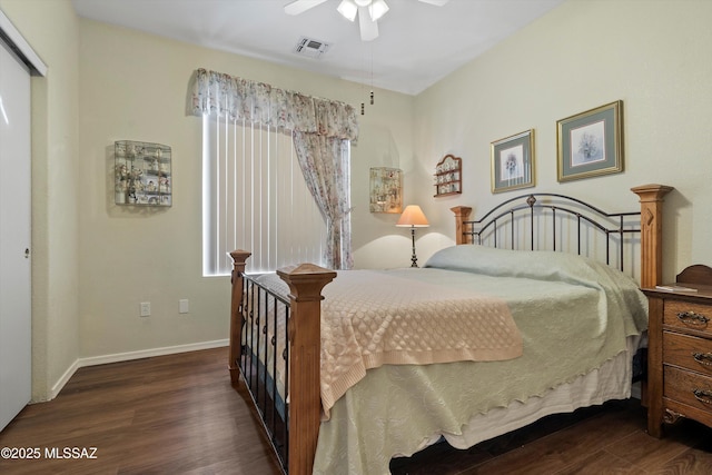 bedroom with ceiling fan, dark hardwood / wood-style flooring, multiple windows, and a closet